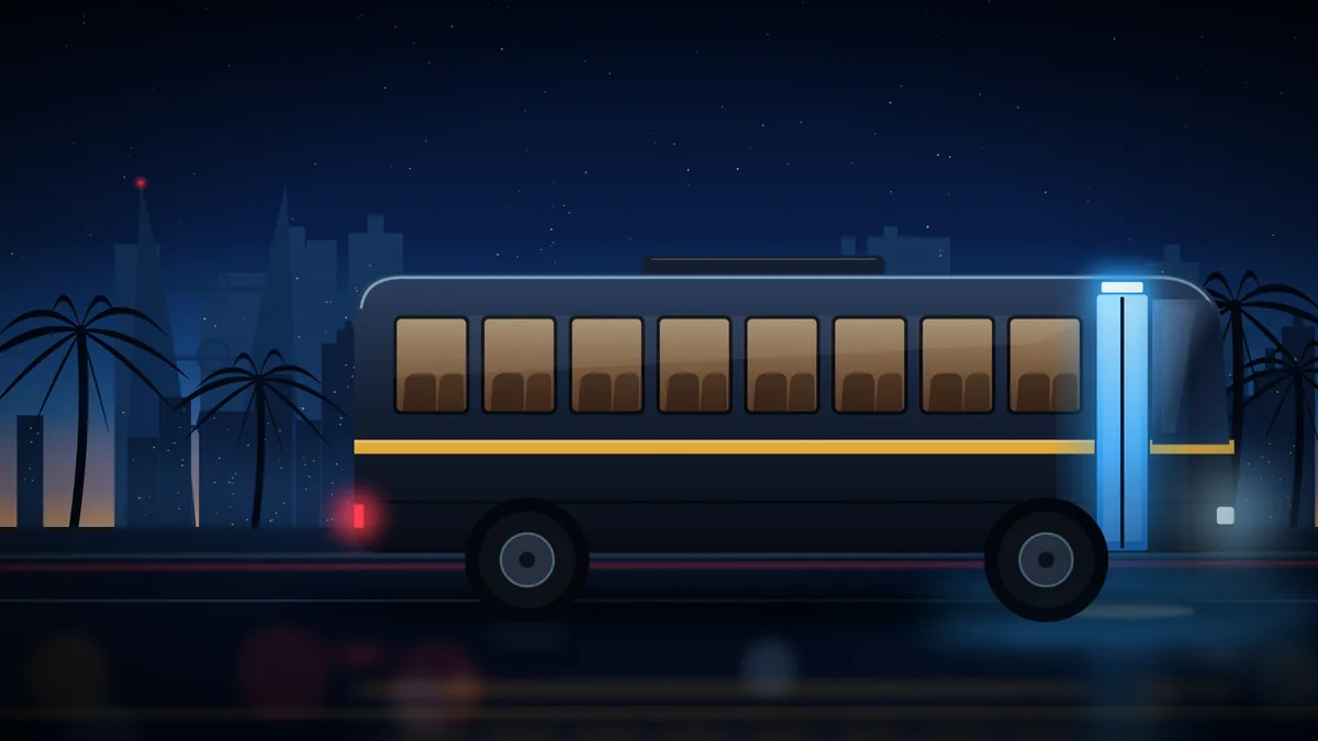 A school bus on a wet Manama road at dusk, its door lit by the Last 1 sensor